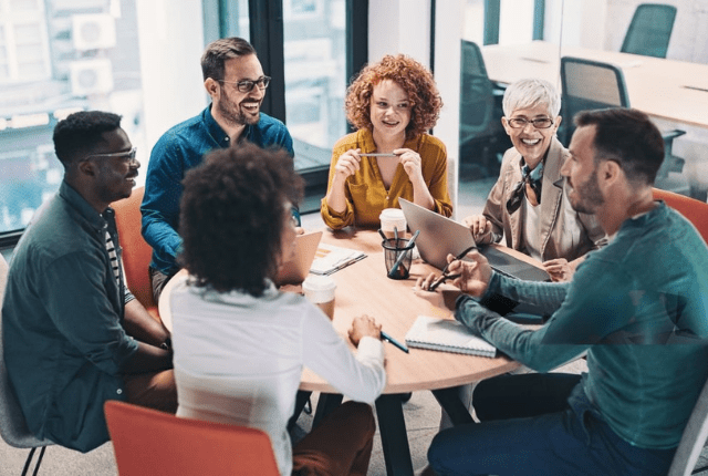 Diverse team collaborating through cross-cultural training to foster positive work communication