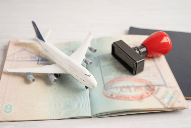 picture of a passport, stamp and airplane showcasing the other services the company provides